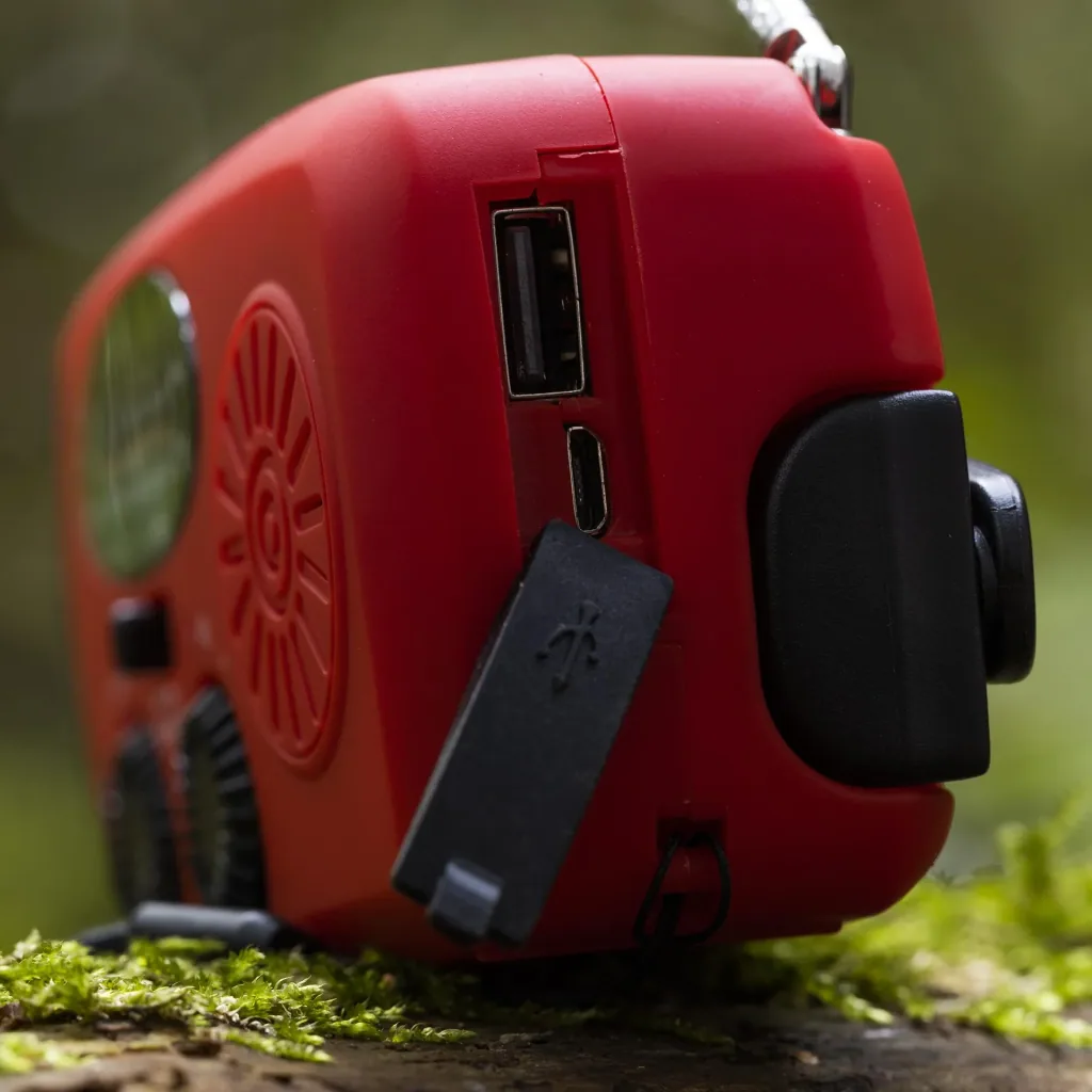 Portable solar crank radio with flashlight, power bank function