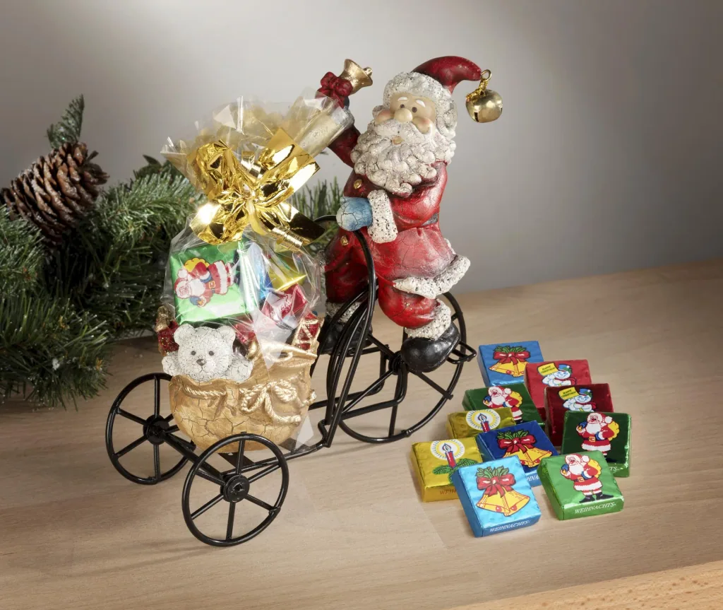 Santa Claus on metal tricycle with tealight holder