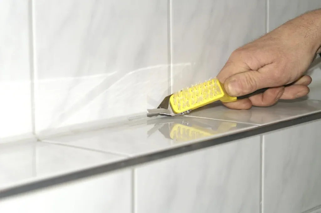 Joint knife with double-sided cutting blade and cleaning brush