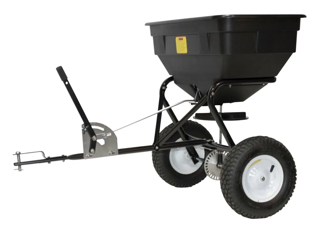 Spreader for lawn tractor attachment