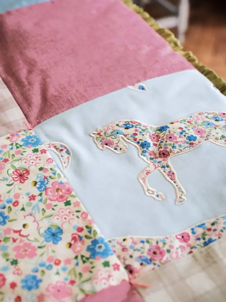 Little Sanderson Abracazoo motif fabric applies horses cream light blue
