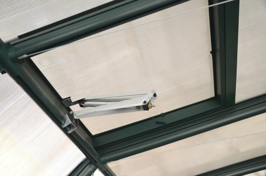 Automatic roof window opener for plastic greenhouses