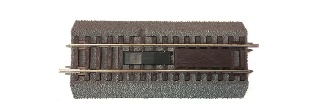 Uncoupling track with integrated electric drive, with bedding, length 115 mm