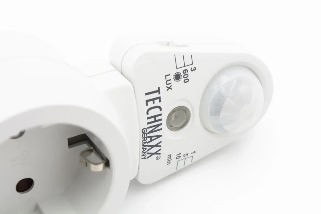 Socket adapter with motion detector and light sensor