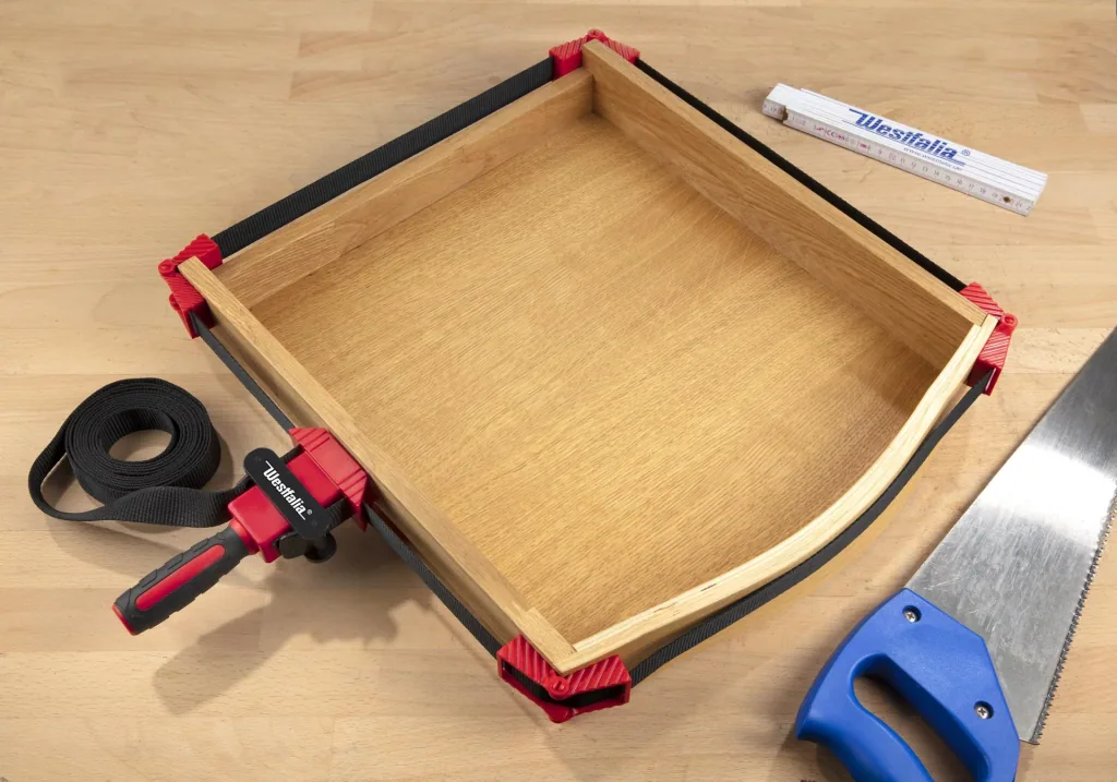 Band tensioners for frames and molds